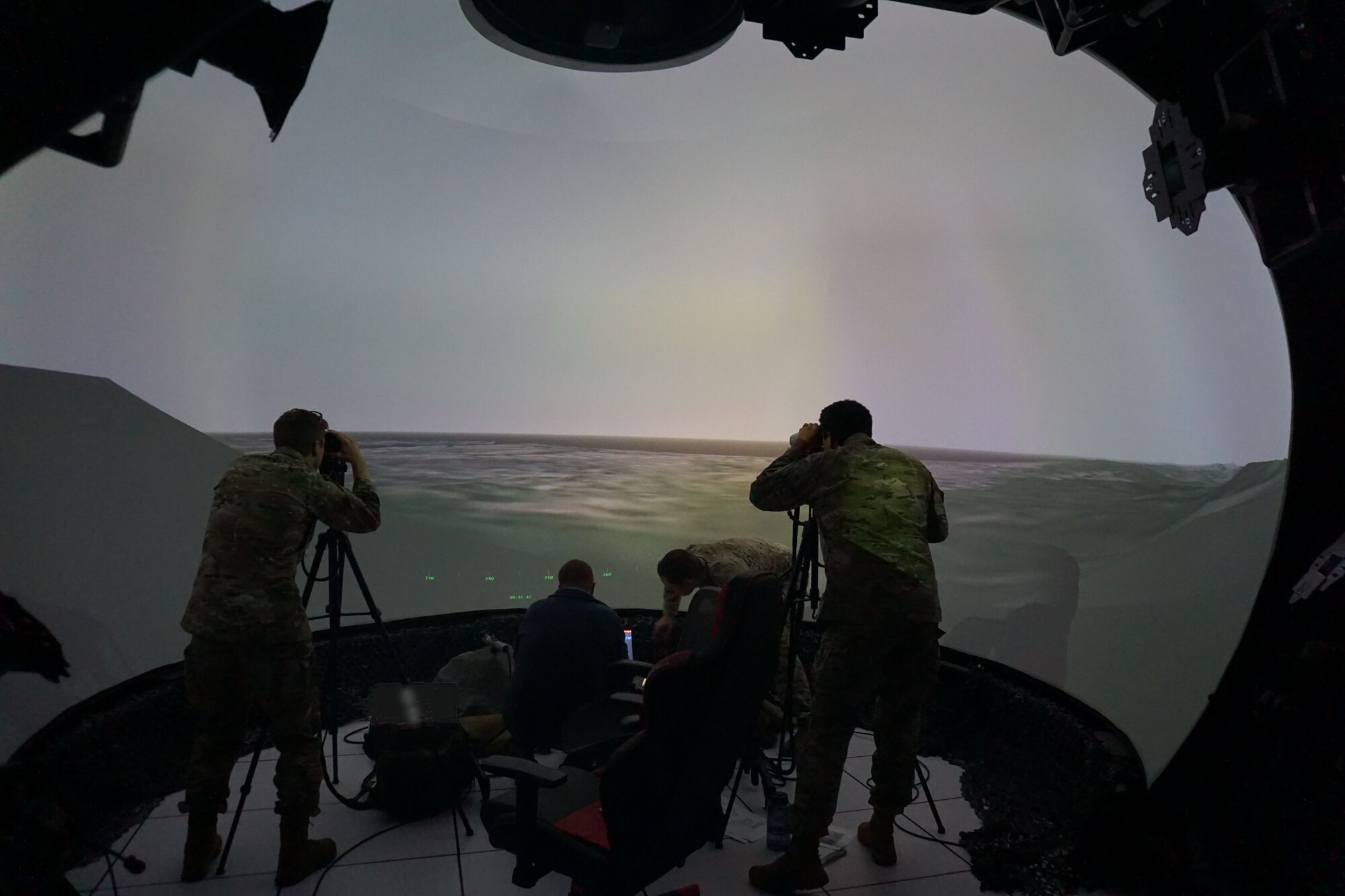 photo of US military members working in a virtual simulator