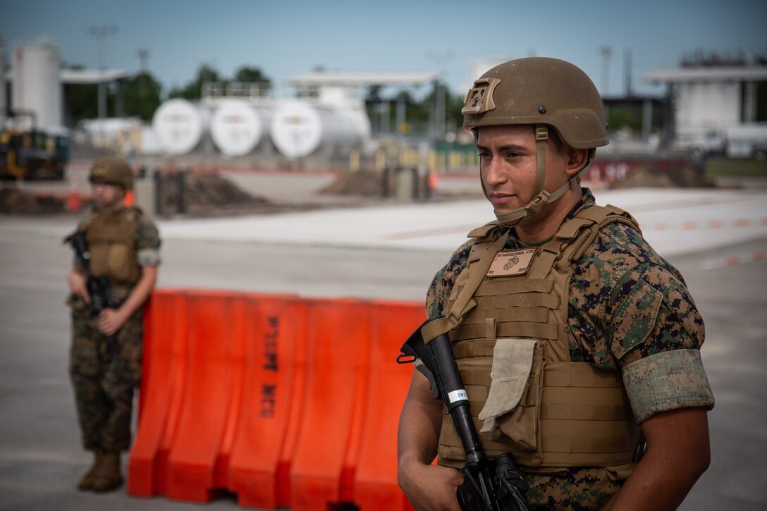 U.S. Marine Corps Pfc. Jason Delgadosalmeron, Raleigh, North Carolina native, distribution management specialist, Headquarters and Support (H&S) Battalion, Marine Corps Installations East (MCIEAST) – Marine Corps Base (MCB) Camp Lejeune, stands guard at a barricade during Exercise Urgent Response on MCB Camp Lejeune, North Carolina, Sept. 15, 2022. H&S Battalion Marines conducted identification checks and established vehicle control points in support of Exercise Urgent Response, an installation-wide exercise that plans for and executes anti-terrorism response procedures. (U.S. Marine Corps photo by Cpl. Trey Q. Michael)