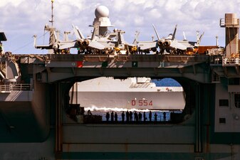 The Italian navy destroyer ITS Caio Duilio ( D 554) is seen through the hangar bay of USS George H.W. Bush (CVN 77) during combined operations in the Adriatic Sea.