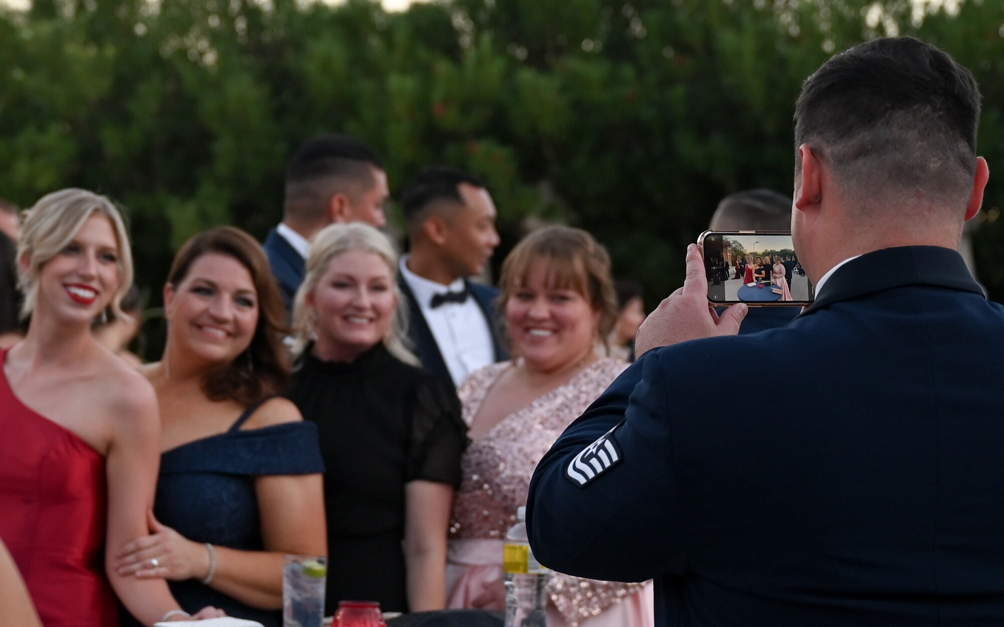 A photo of a person taking a photo of people dressed up.