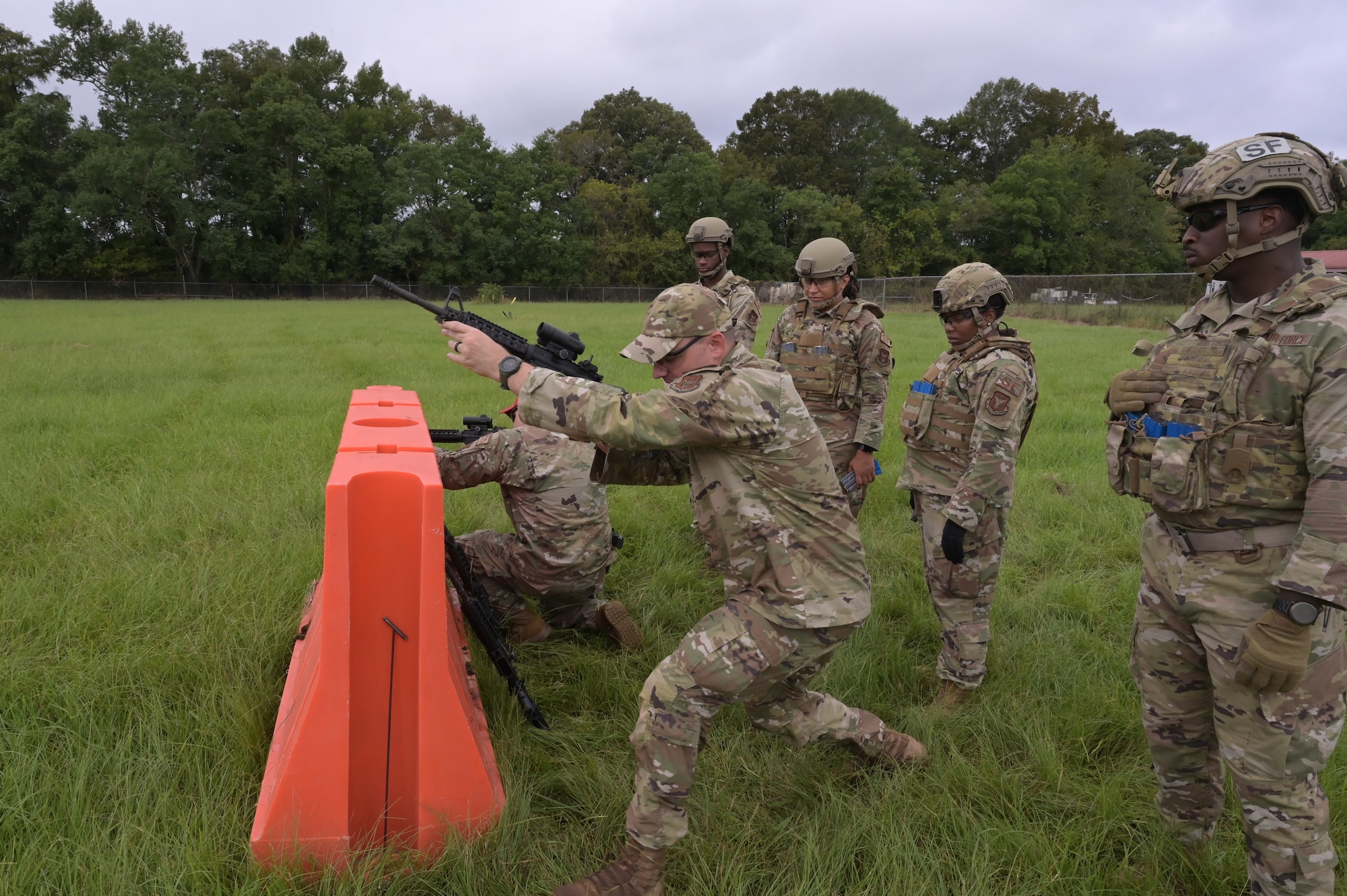 a man demonstrates cover techniques to a class