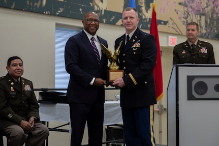 Johnny Danrich III, left, awards 2nd Lt. Michael Goodin with the Honor Graduate Award during Goodin's OCS graduation ceremony in Norman, Okla. Sept. 18, 2022. Danrich presented the award to Goodin on behalf of the National Guard Association of Oklahoma. For his initial assignment, Goodin will be serving with Company A, 777th Aviation Support Battalion (Air Assault), 345th Combat Sustainment Support Battalion, 90th Troop Command. (Oklahoma National Guard photo by Spc. Haden Tolbert)