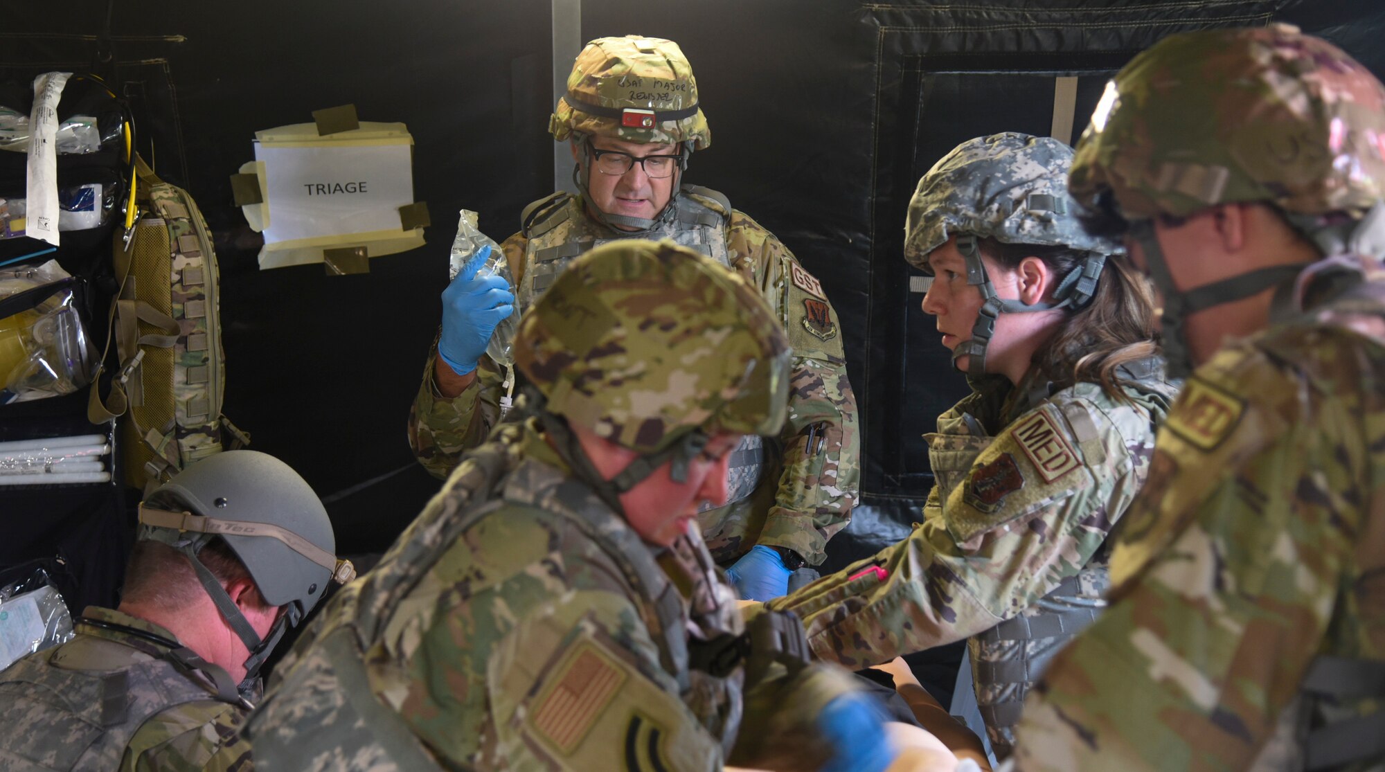 airmen provide aid to a simulated casualty during a readiness exercise on Friday