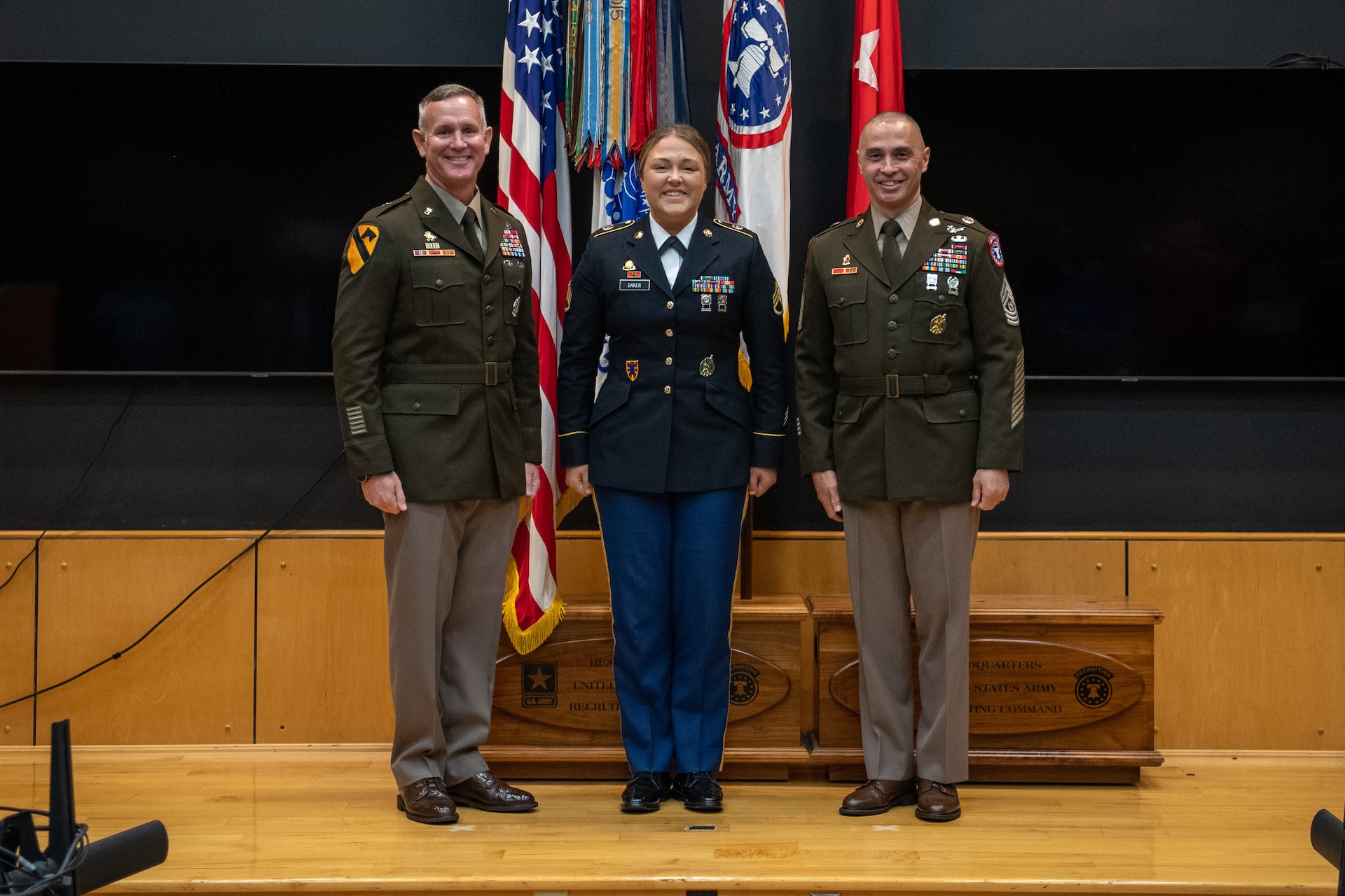 a woman wearing a u.s. army uniform stands in a hallway