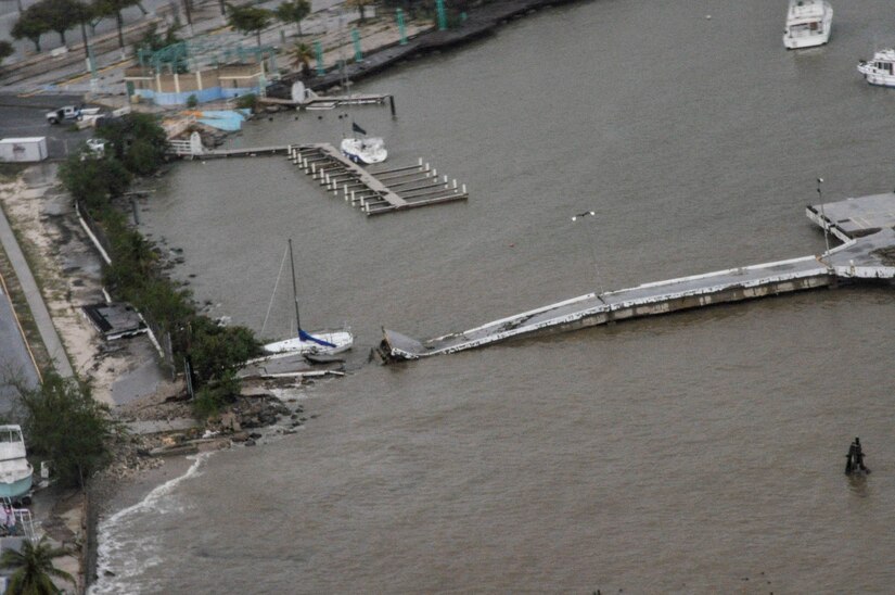 Several structures and equipment are damaged after a hurricane.