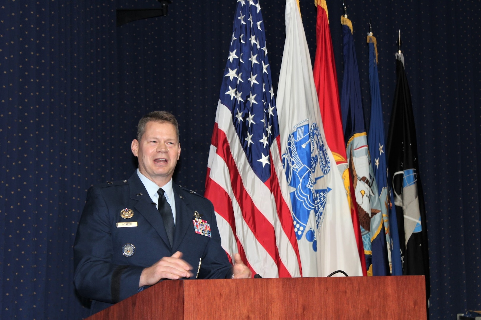 Air Force airman speaks at a podium