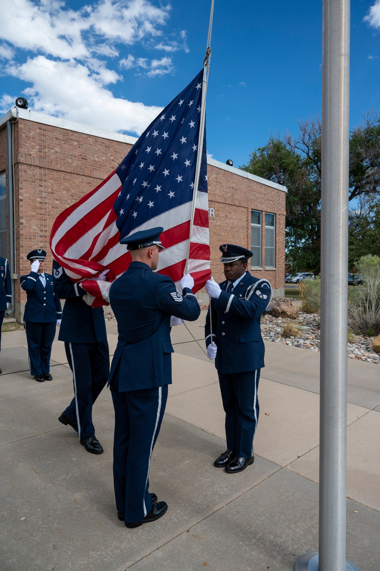 Members of the High Frontier Honor Guard lower the U.S. Flag during the Space Base Delta 1 POW/MIA Retreat Ceremony at Peterson Space Force Base, Colorado, Sept. 16, 2022. The retreat ceremony was the final event of the 2022 POW/MIA Remembrance Week.  (U.S. Space Force photo by Airman 1st Class Aaron Edwards.)