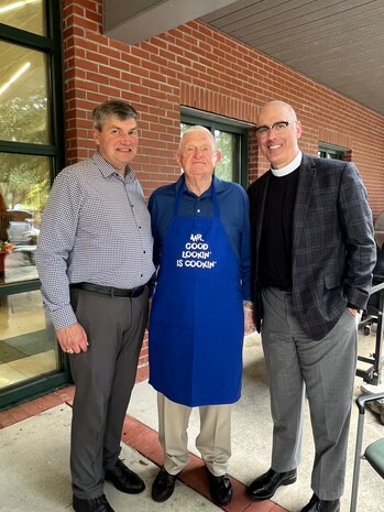 Three people pose for a photo.