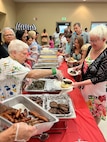Volunteers pass out food at a Chapel event.