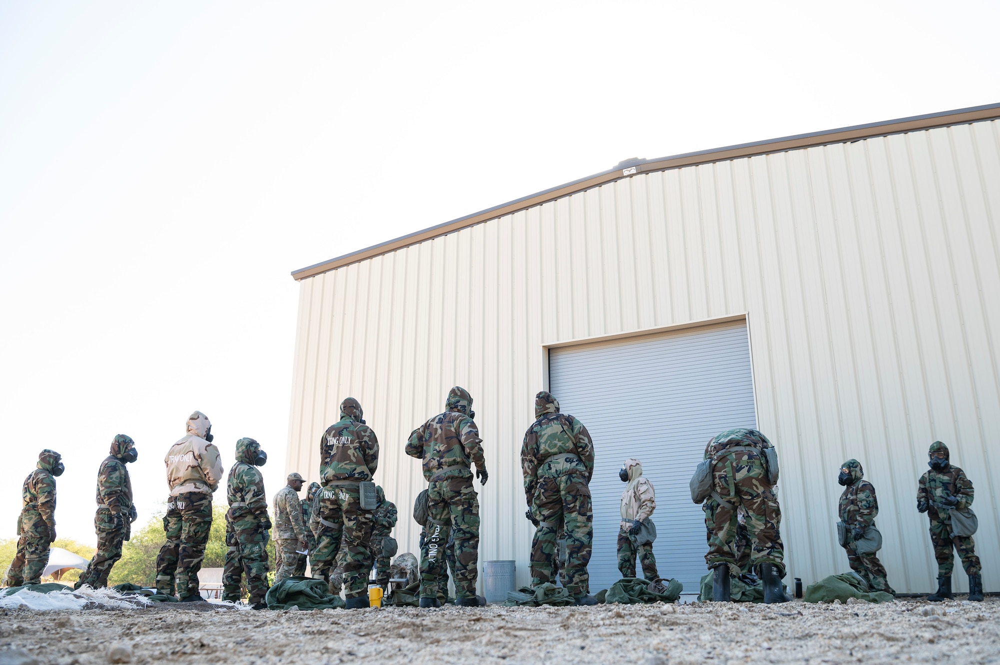 Airmen put on a components of Mission Oriented Protective Posture gear, during a chemical, biological, radiological and nuclear defense exercise Sept. 14, 2022, at Joint Base Pearl Harbor-Hickam, Hawaii. MOPP gear is designed to keep CBRN agents from harming the wearer. CBRN defenses are protective measures taken in situations in which chemical, biological, radiological or nuclear warfare hazards may be present. (U.S. Air Force photo by Staff Sgt. Jacob M. Thompson)