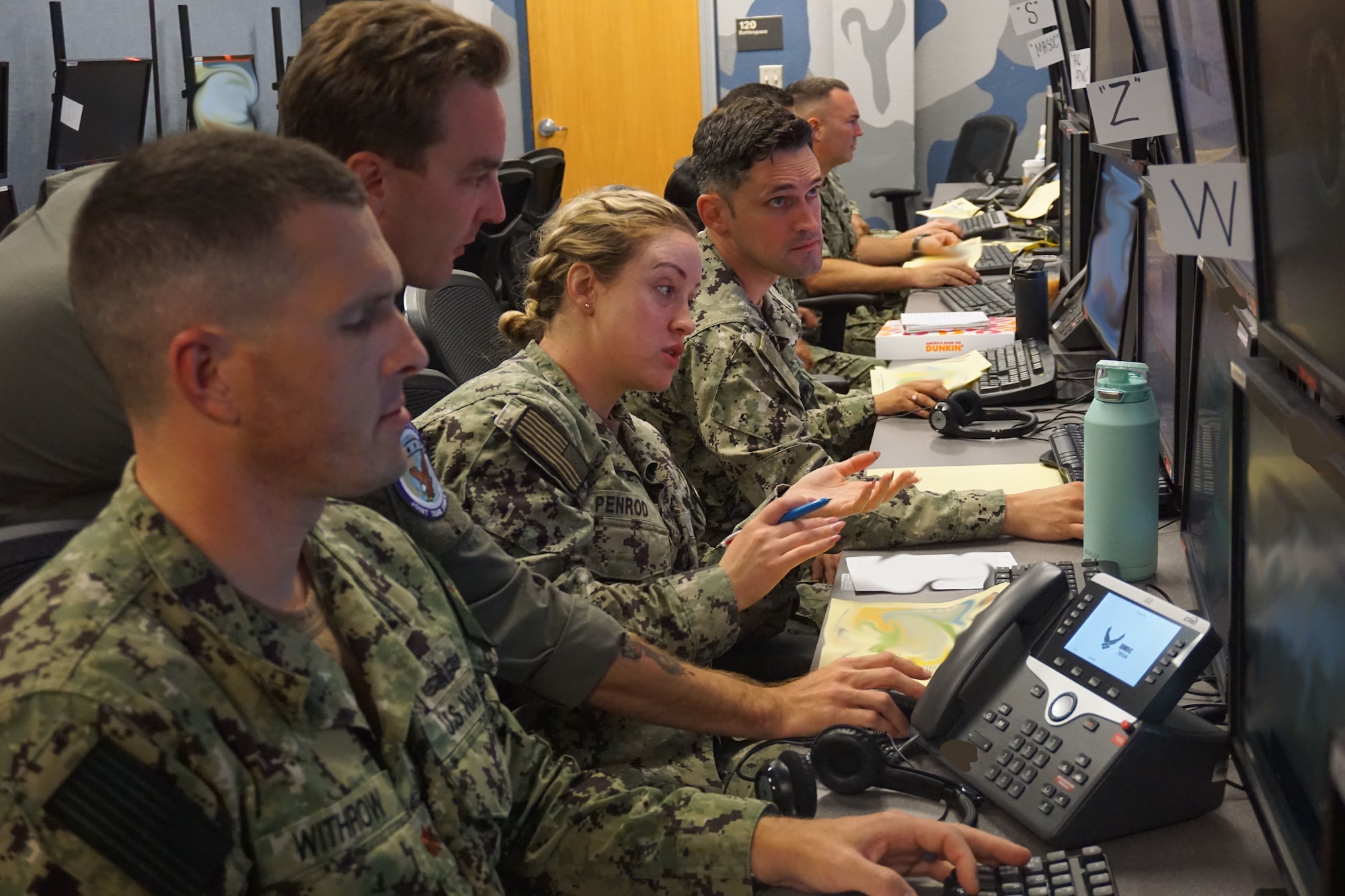 photo of US Military members sitting working at computers