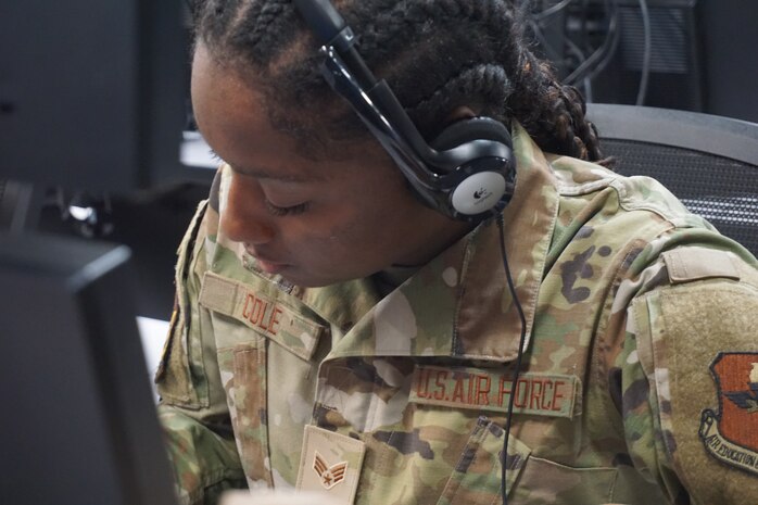 photo of US Military member sitting working at a computer