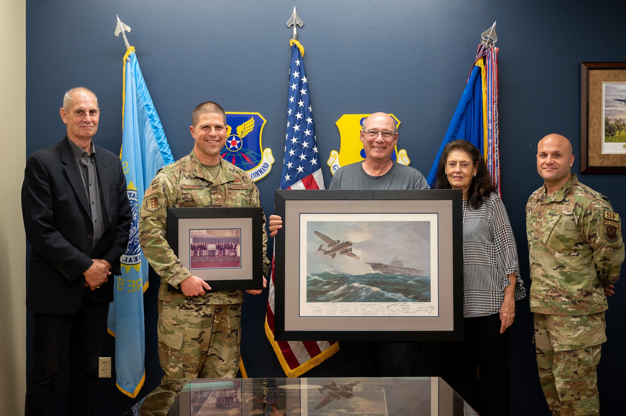 Descendants of a Doolittle Raider present the 28th Bomb Wing gifts at Ellsworth AFB, S.D., Sept. 16, 2022. This year marks the 80th anniversary of the Doolittle Raid, in which 200 volunteers delivered the first long-range strike of World War II. (U.S. Air Force Photo by Senior Airman Austin McIntosh)