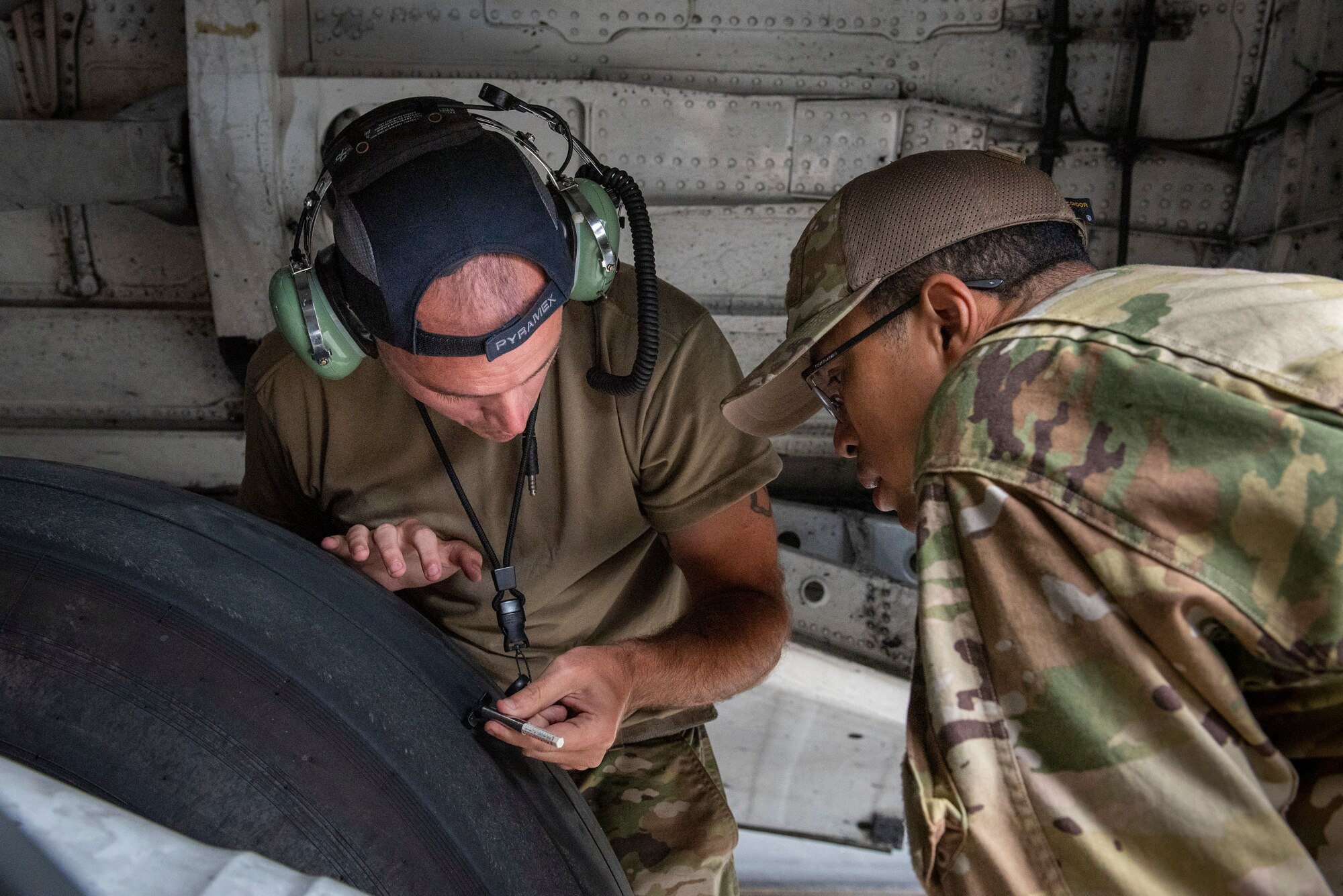 Reserve Citizen Airmen from the 712th Aircraft Maintenance Squadron, Dover Air Force Base, Del., check the depth of a C-17 Globemaster III aircraft tire, Sept. 11, 2022. The maintainers performed routine preflight checks prior to a local flight by the 326th Airlift Squadron to Westover Air Reserve Base, Mass. (U.S. Air Force photo by Senior Airman Ruben Rios)