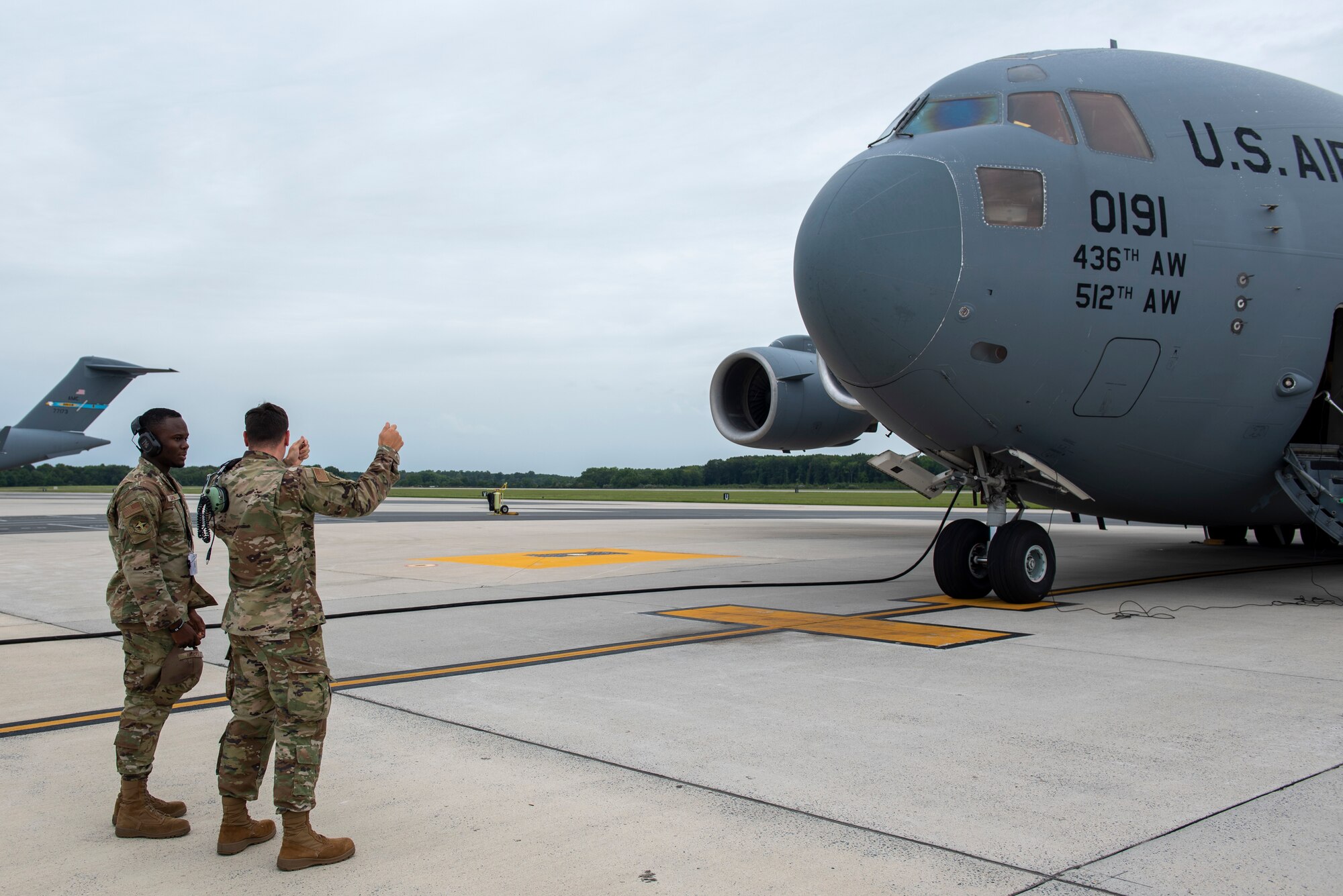 Reserve Citizen Airmen from the 712th Aircraft Maintenance Squadron, Dover Air Force Base, Del., review marshaling prior to the departure of a C-17 Globemaster III aircraft, Sept. 11, 2022. The 326th Airlift Squadron provided the airlift for the 439th Aeromedical Evacuation Squadron, Westover Air Reserve Base, Massachusetts, so they could conduct readiness training, including medical operations before, during and after the flight.  (U.S. Air Force photo by Senior Airman Ruben Rios)