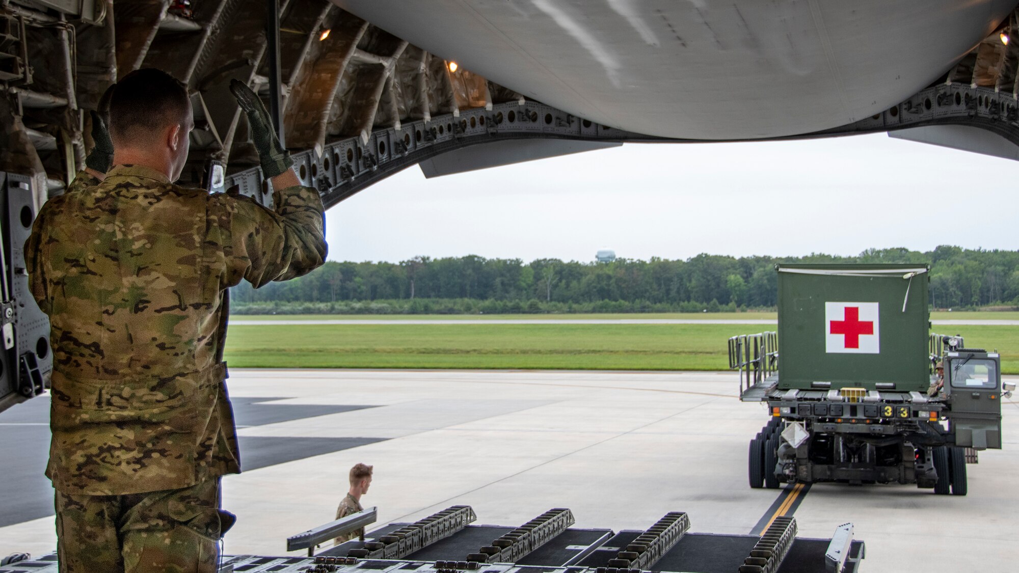 U.S. Air Force Tech. Sgt. Brian Gorman, 326th Airlift Squadron loadmaster, guides a K-Loader with aeromedical evacuation equipment onto a C-17 Globemaster III aircraft, Sept. 11, 2022. The 326th AS provided the airlift for the 439th Aeromedical Evacuation Squadron, Westover Air Reserve Base, Massachusetts, so they could conduct readiness training, including medical operations before, during and after the flight.  (U.S. Air Force photo by Senior Airman Kalee Sexton)