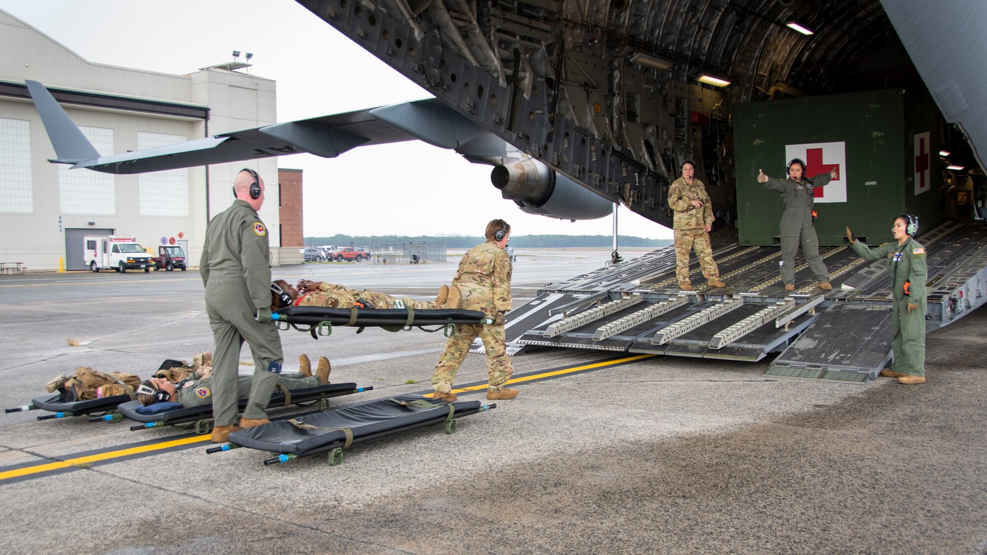 Reserve Citizen Airmen from the 439th Aeromedical Evacuation Squadron, Westover Air Reserve Base, Massachusetts, carry AE equipment onto a C-17 Globemaster III aircraft, Sept. 11, 2022. The 326th Airlift Squadron, Dover Air Force Base, Del., provided the airlift for the 439th AES so they could conduct readiness training, including medical operations before, during and after the flight.  (U.S. Air Force photo by Senior Airman Kalee Sexton)
