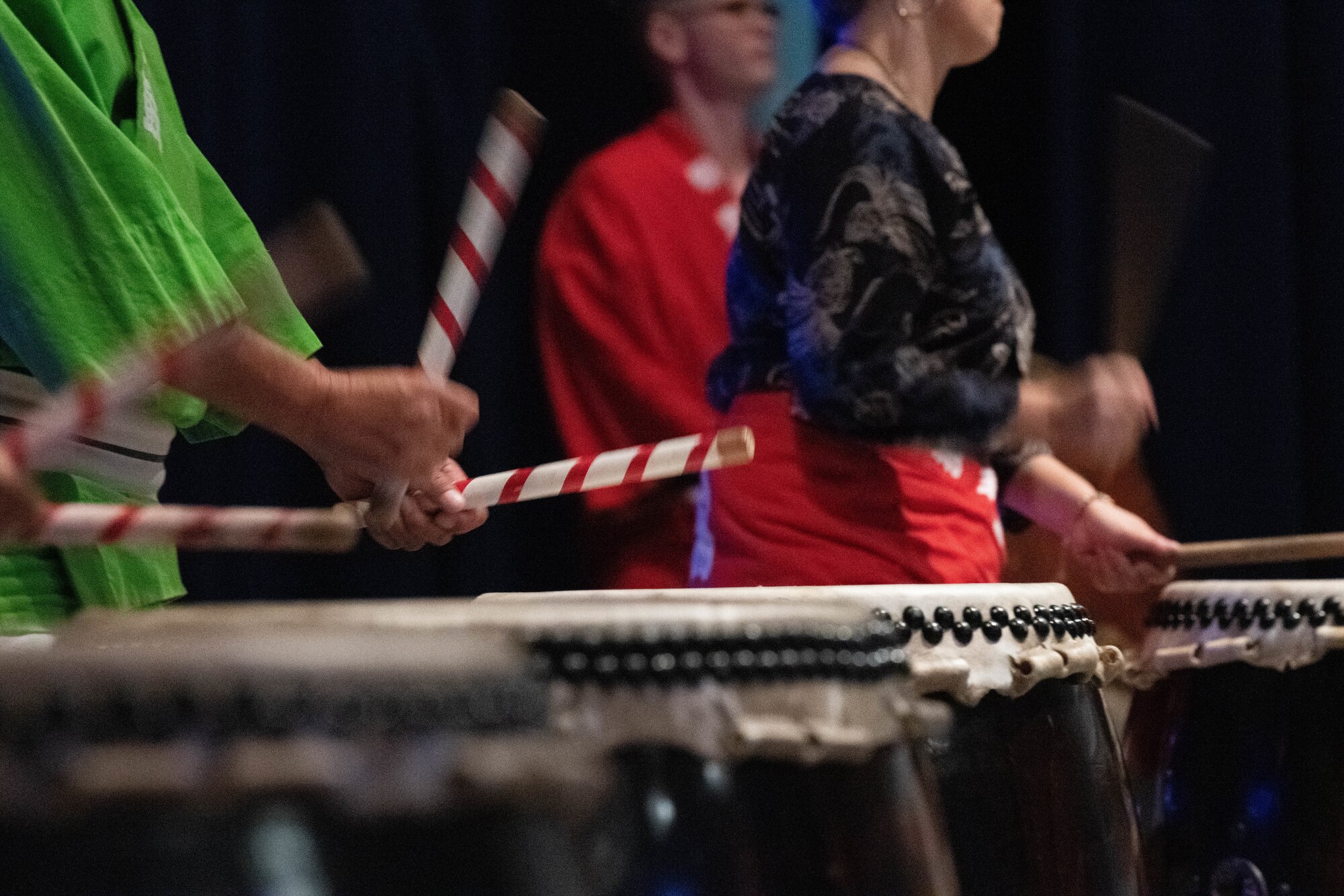 Bachi drumsticks beat against taiko drums