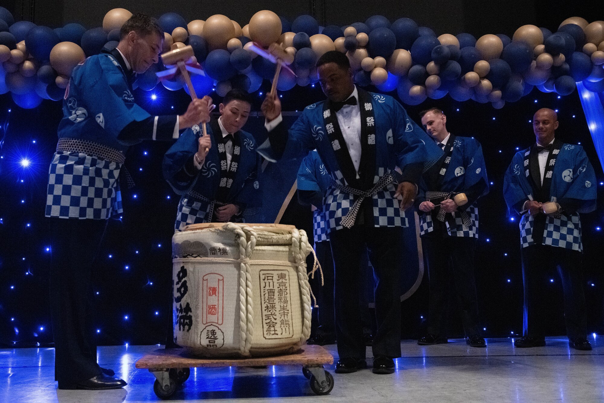 Airmen break open a cask of Japanese sake