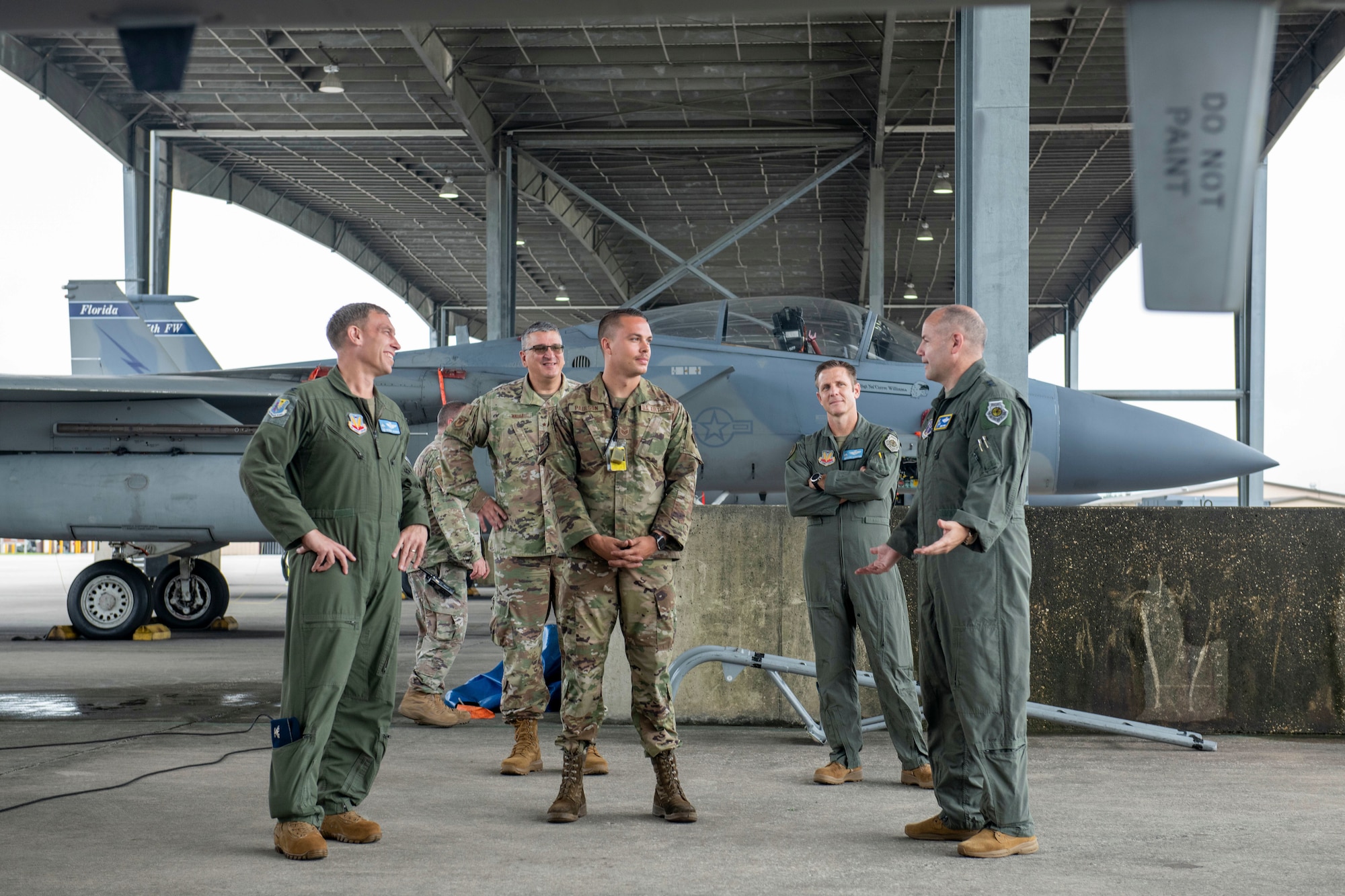 From left: U.S. Air Force Col. George Downs, commander, 125th Fighter Wing, Florida National Gurd, Brig. Gen. Michael Valle, assistant adjutant general – Air, Florida National Guard, Staff Sgt. Bryce Paulson, crew chief, 125th Aircraft Maintenance, 125th Fighter Wing, Lt. Col. Jonathan Kassebaum, unit conversion director, F-35A Lightning II, and Maj. Gen. Duke Pirak, deputy director, Air National Guard, talk while on the flightline of the Jacksonville Air National Guard Base, Florida, Sept. 13, 2022. Pirak was welcomed by 125th Fighter Wing officials for a mission brief, an F-35A Lightning II conversion update and meet-and-greet with Airmen. (U.S. Air National Guard photo by Tech. Sgt. Chelsea Smith) (This image was altered for security reasons to blur out line badge information)