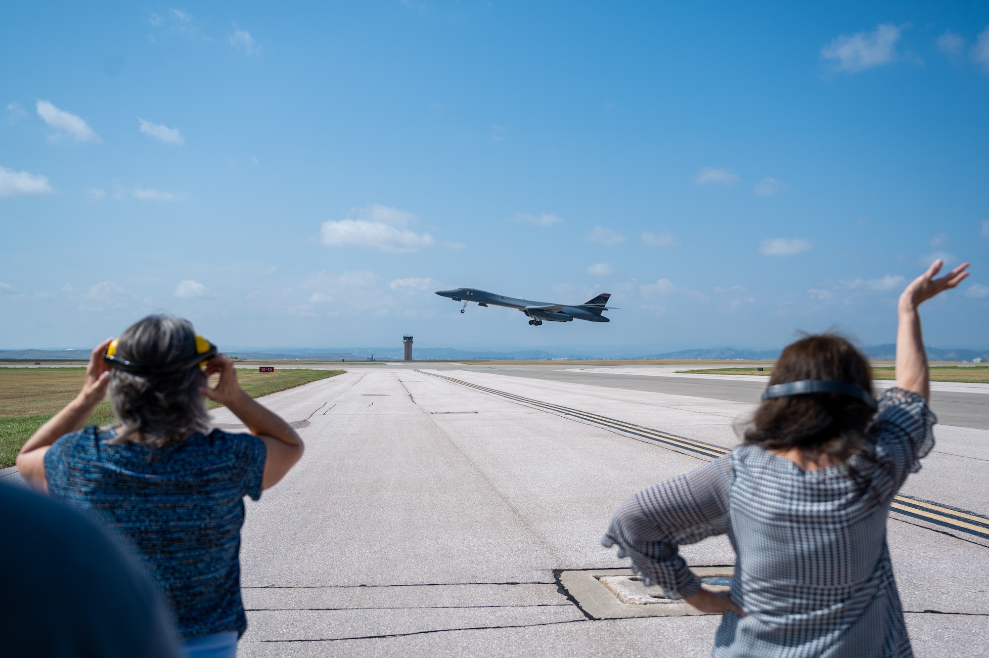Susan Bower (Left) and Cindy Cole Chal (Right) view a B-1B Lancer takeoff at Ellsworth AFB, S.D. on Sept 16, 2022. The Lancer is a highly versatile, aircraft that carries on the legacy of the Doolittle Raid, providing worldwide long-range-strike capabilities. (U.S. Air Force Photo by Senior Airman Austin McIntosh)
