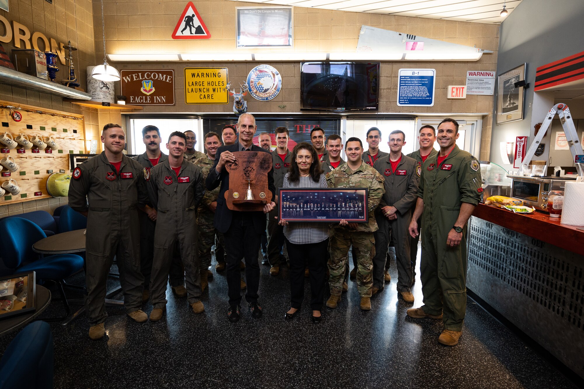 Descendants of Richard Cole, a Doolittle Raid participant, present the 34th Bomb Squadron with a gift in honor of their father at Ellsworth AFB, S.D., Sept. 16, 2022. Ellsworth is home to three of the four squadrons that flew during the Doolittle Raid in 1942.  (U.S. Air Force Photo by Senior Airman Austin McIntosh)