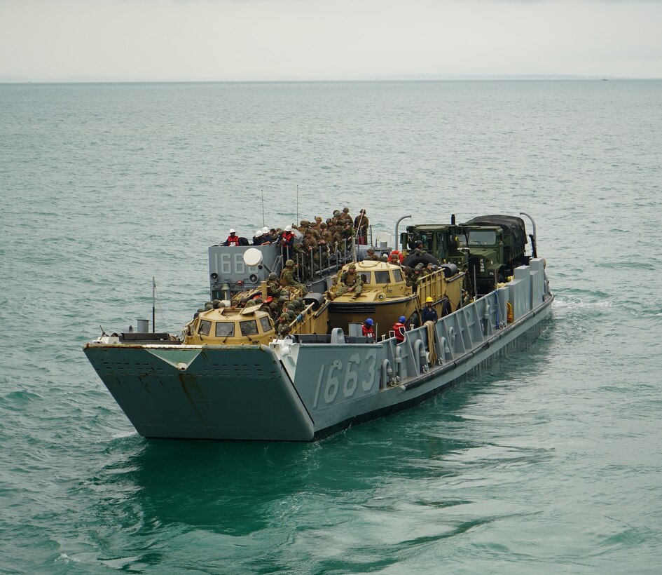Landing Craft Unit (LCU) 1663, assigned to the San Antonio-class amphibious transport dock USS Mesa Verde (LPD 19), carries United States, Brazilian, Uruguayan, and Chilean Marines along with vehicles, gear, equipment toward the coastline of Itaoca, Brazil as the first wave of an international, joint, and combined amphibious landing during the culminating event of exercise UNITAS LXIII, Sept. 16, 2022.