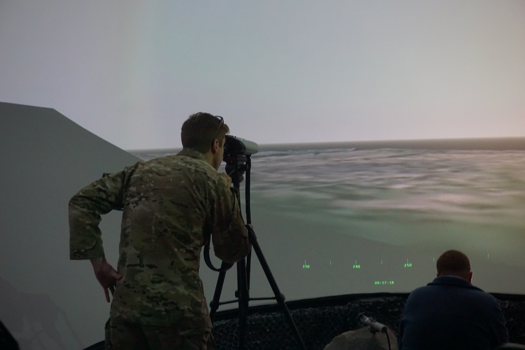 photo of US military members working in a virtual simulator