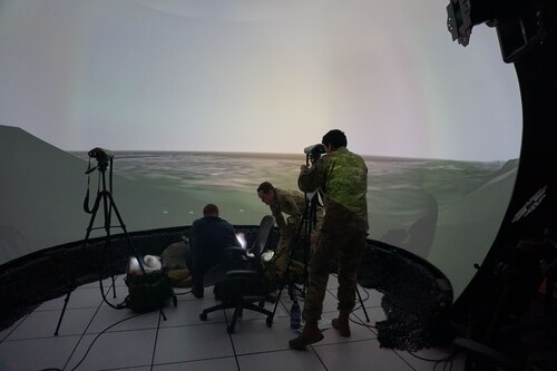 US military members working in a virtual simulator environment
