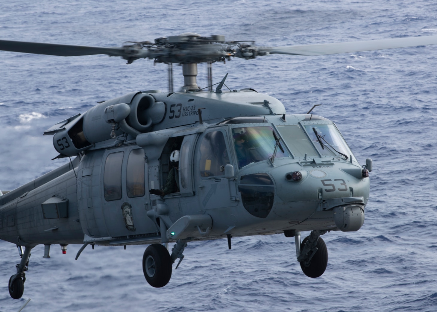 An MH-60S Sea Hawk helicopter assigned to Helicopter Sea Combat Squadron (HSC) 23 takes off from the flight deck of the amphibious assault ship USS Tripoli (LHA 7) Sept. 19, 2022.