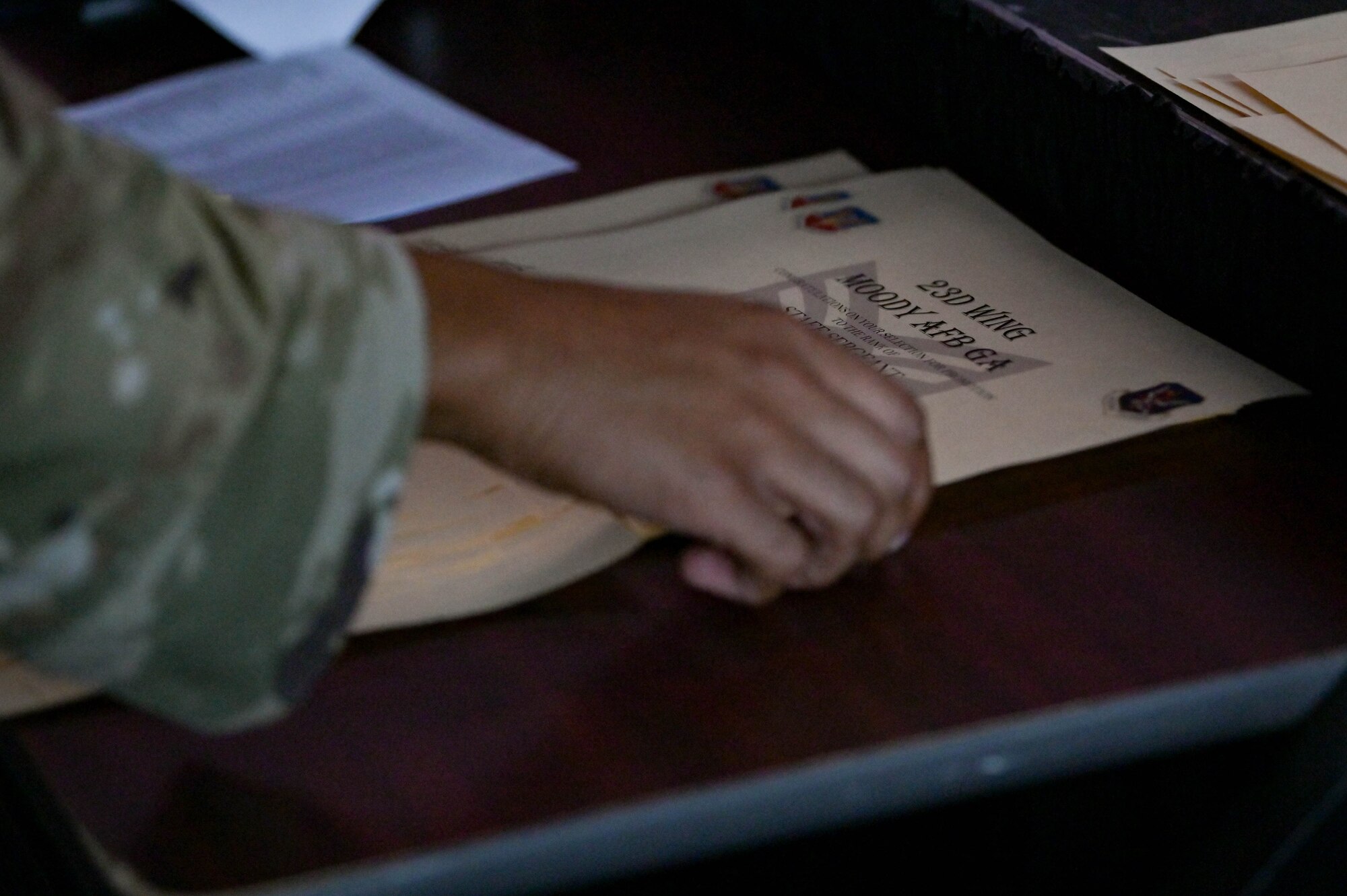 U.S. Air Force Staff Sgt. Tyler Herbert, 23rd Security Forces Squadron combat arms instructor, organizes staff sergeant promotion certificates, Sept. 16, 2022, at Moody Air Force Base, Georgia. Staff sergeant is the first rank in the non-commissioned officer tier, bridging the gap between Airmen and Senior NCOs. (U.S. Air Force photo by Senior Airman Rebeckah Medeiros)
