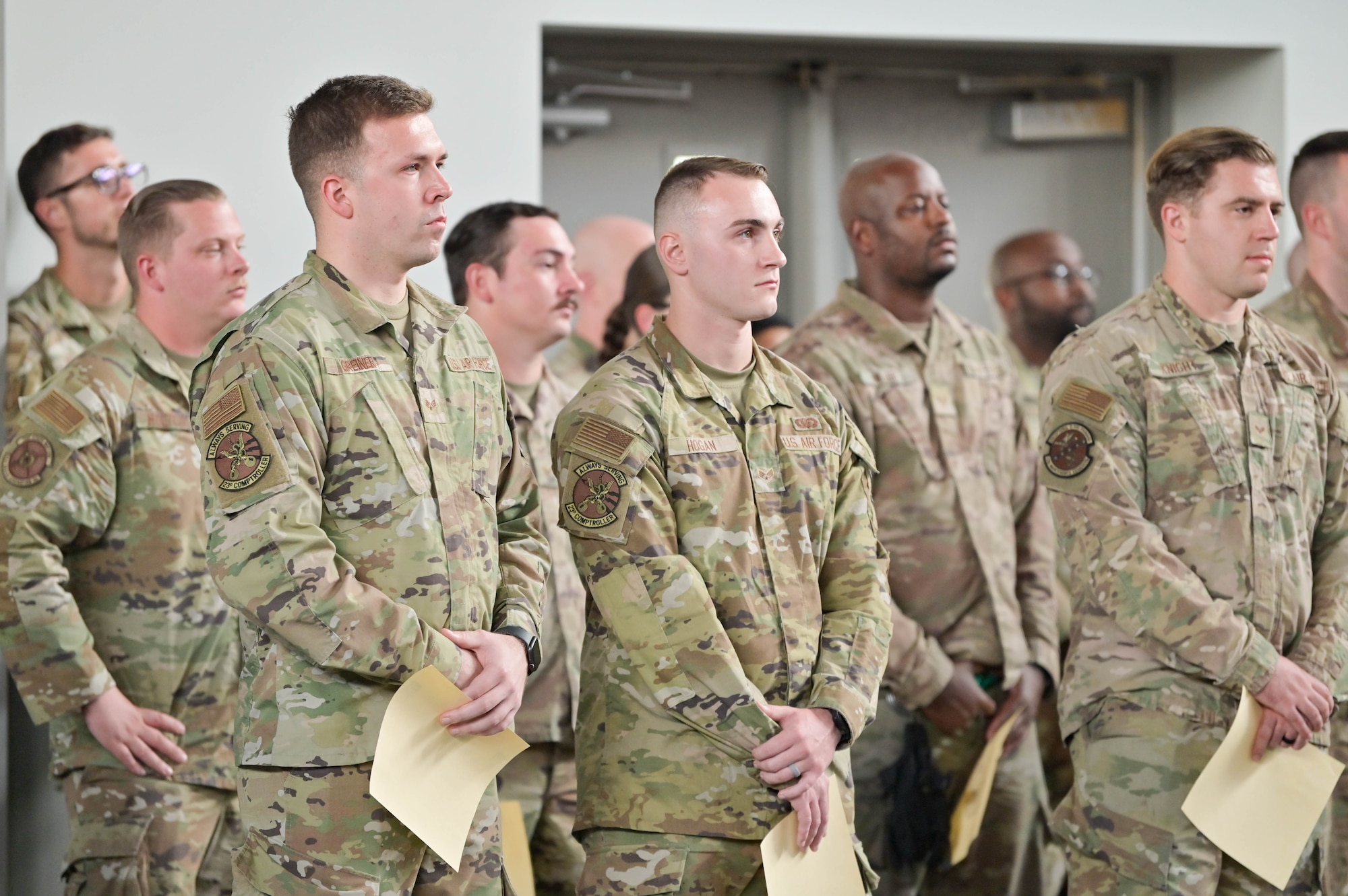 U.S. Air Force Airmen gather for an announcement from Col. Russell Cook, 23rd Wing commander, after receiving their promotion certificates, Sept. 16, 2022, at Moody Air Force Base, Georgia. Staff sergeant is the first rank in the non-commissioned officer tier, bridging the gap between Airmen and Senior NCOs. (U.S. Air Force photo by Senior Airman Rebeckah Medeiros)