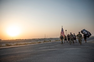 Members from the 386 Air Expeditionary Wing march throughout the evening at Ali Al Salem Air Base, Kuwaiti, 11 Sept. 2022 in remembrance of those lost on Sept. 11, 2001. Members from multiple branches of service and coalition teammates from throughout the world took part in the 24-hour march. (U.S. Air Force photo by Senior Master Sgt. David Salanitri)