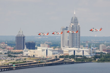 U.S. Coast Guard Aviation Training Center, Mobile Alabama.  Four Coast Guard MH-60T Helicopters fly in formation over Mobile Bay.  Official U.S. Coast Guard Photograph by Phillip Floyd