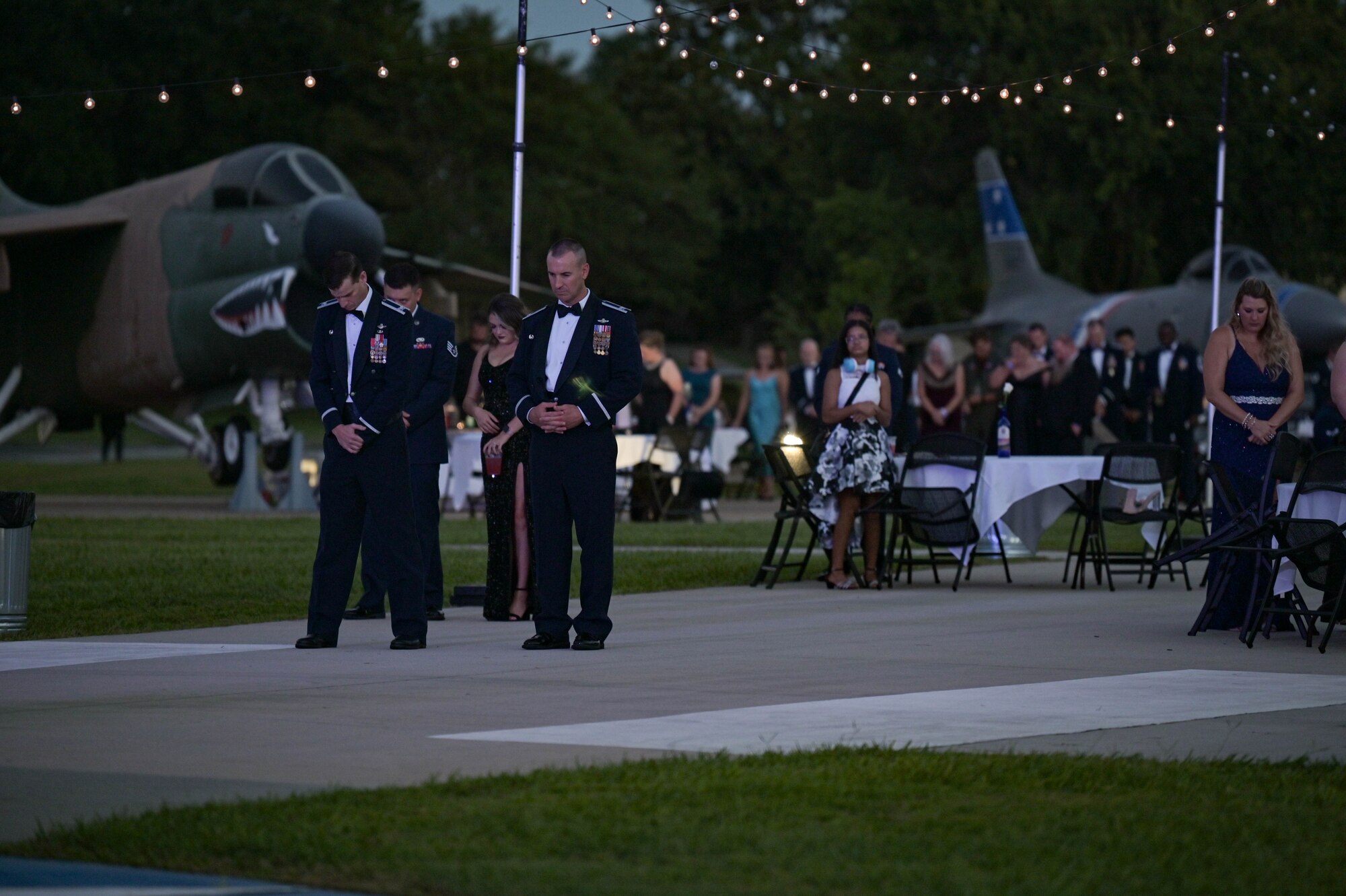 U.S. Air Force Col. Russell Cook, 23rd Wing commander, left, and Col. Timothy Hood, 93rd Air Ground Operations Wing commander, stand at the front of the George W. Bush Air Park for a prayer during the 75th Air Force Ball, Sept. 17, 2022, at Moody Air Force Base, Georgia. The Air Force Ball celebrates 75 years of tradition and Airmen answering their nation's call to serve their country. (U.S. Air Force photo by Senior Airman Rebeckah Medeiros)