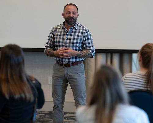 A guest speaker stands in front of an audience.