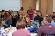 Attendees of the 2022 Building Resilient Leaders smile and laugh during an art activity.
