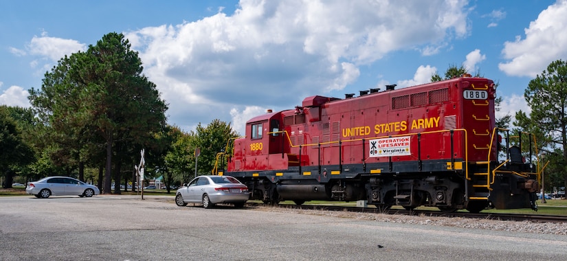 Train and crashed car next to railroad crossing