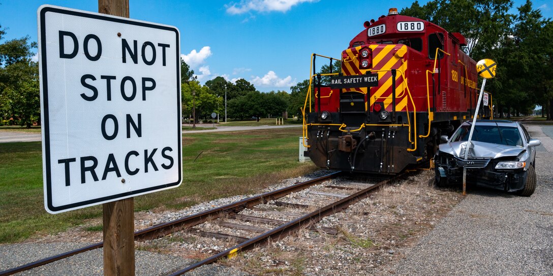 Train and crashed car next to railroad crossing