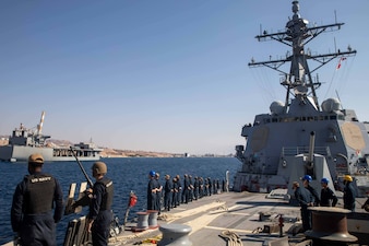 Sailors man the rails as the guided-missile destroyer USS Nitze (DDG 94) pulls into the port of Eilat, Israel.