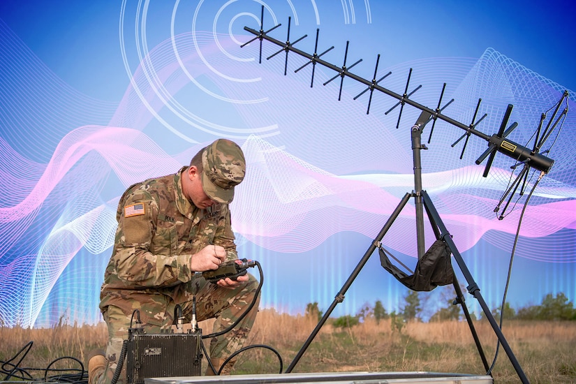 An illustration depicting a soldier kneeling in the grass and operating electronic equipment is shown.