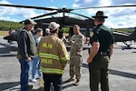 New Hampshire Adjutant Gen. David Mikolaities meets with town officials and residents alongside a NHARNG Black Hawk helicopter during a Berlin Regional Airport open house Sept. 16, 2022, in Milan, New Hampshire.