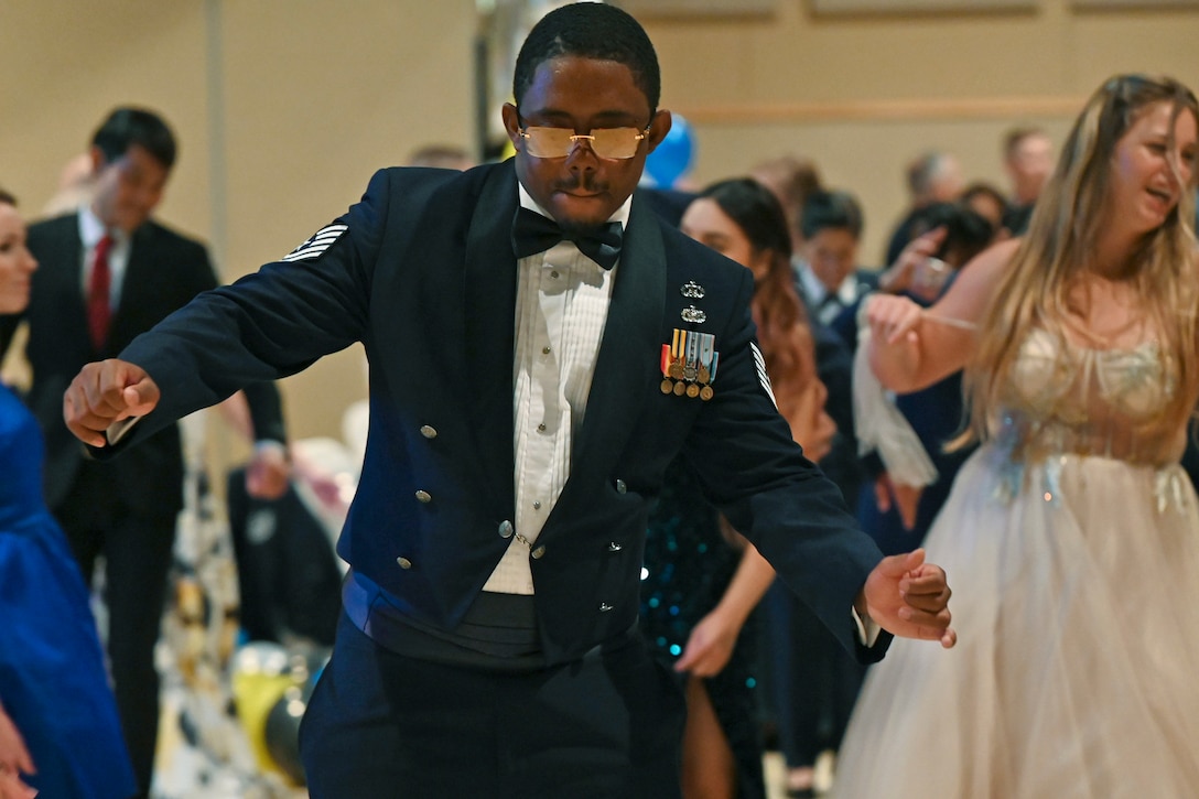 An airman dances at a ball.