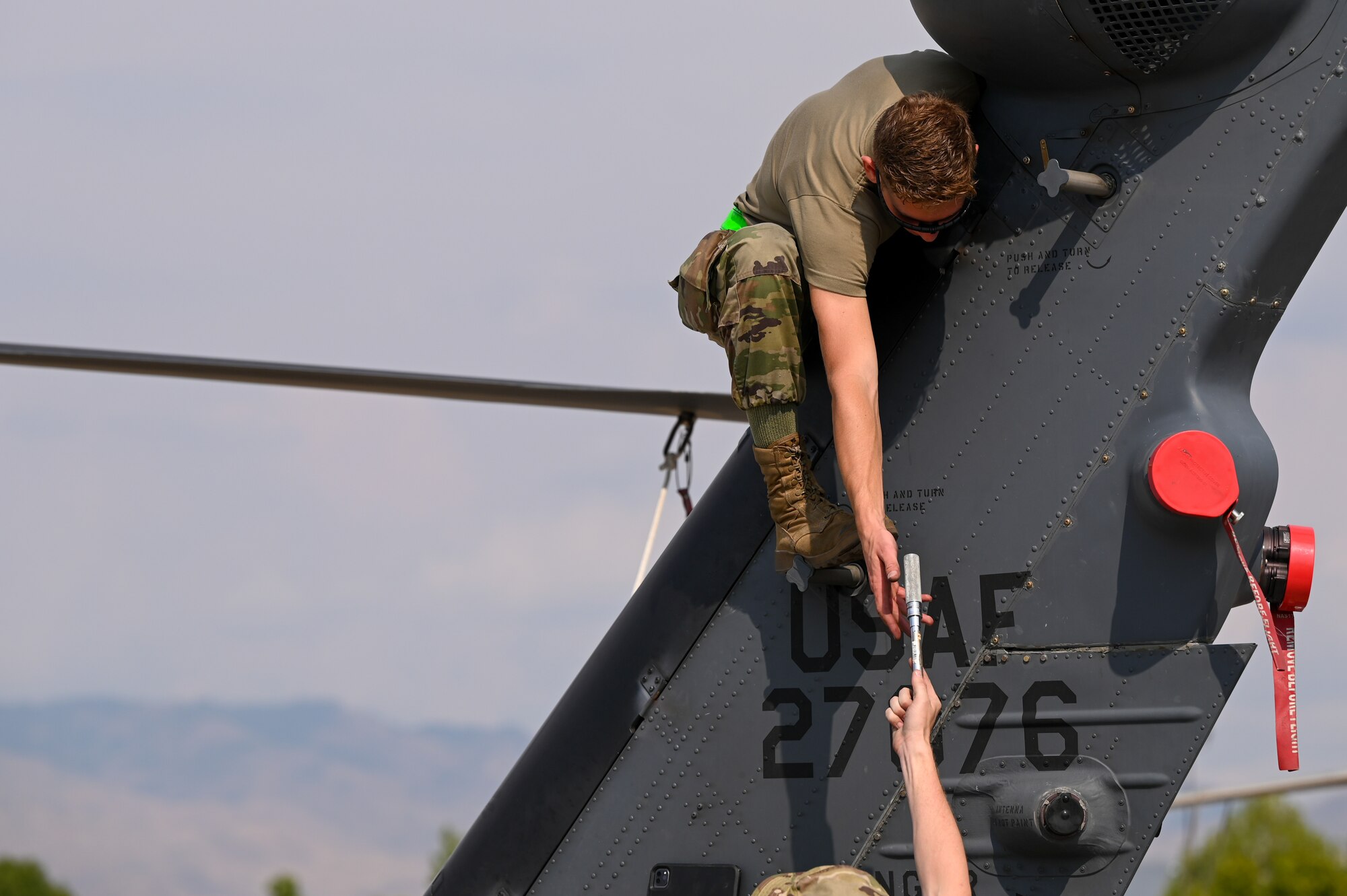 A photo of an Airman repairing an HH-60G Pavehawk.