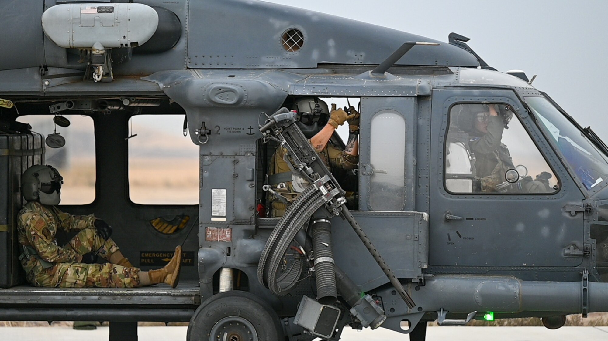 A photo of an Airman in a HH-60G Pavehawk.