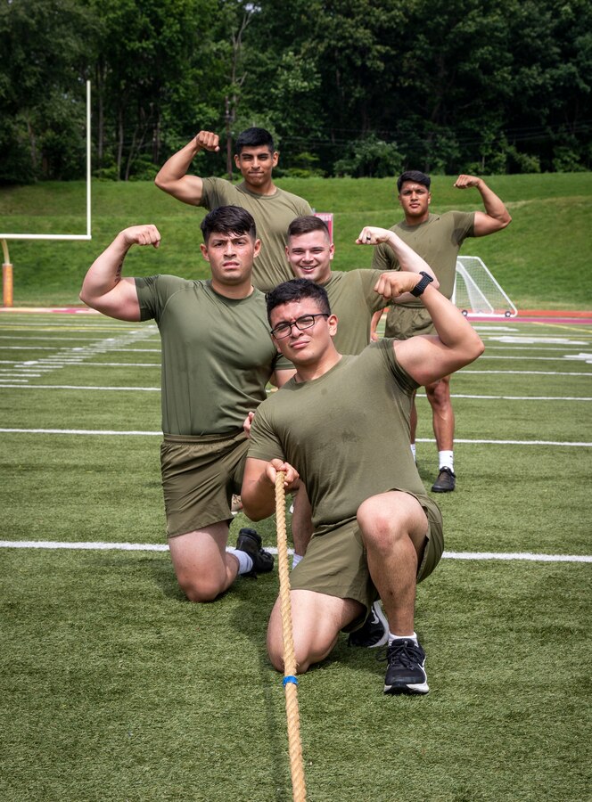 U.S. Marines with Security Battalion participate in a tug-of-war competition during a field meet at Butler Stadium on Marine Corps Base Quantico, Virginia, June 24, 2022. Field meets test the Marines physical fitness through competitive team events while boosting morale and camaraderie. The meet included a water carry relay race, tug-of-war competition, and fast paced musical chairs. Team Wee-Woo from the Provost Marshal Office finished in first place, followed by Team COMMSTRAT from Communication Strategy and Operations in second place. (U.S. Marine Corps photo by Ashley L. Boster)