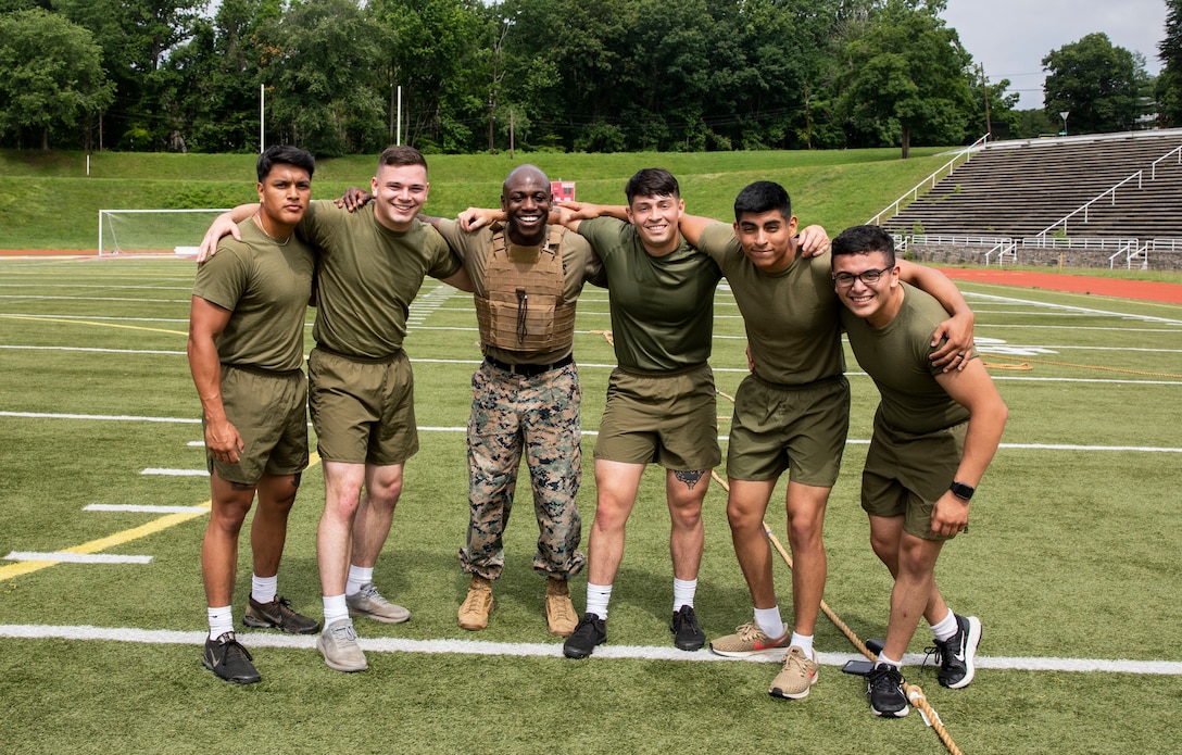 U.S. Marines with Security Battalion participate in a tug-of-war competition during a field meet at Butler Stadium on Marine Corps Base Quantico, Virginia, June 24, 2022. Field meets test the Marines physical fitness through competitive team events while boosting morale and camaraderie. The meet included a water carry relay race, tug-of-war competition, and fast paced musical chairs. Team Wee-Woo from the Provost Marshal Office finished in first place, followed by Team COMMSTRAT from Communication Strategy and Operations in second place. (U.S. Marine Corps photo by Ashley L. Boster)