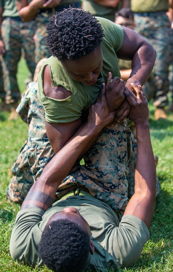 U.S. Marine Corps Cpl. Djefson Thelusma and U.S. Navy Seaman Apprentice Mickel Smith grapple during a Security Battalion field meet on Marine Corps Base Quantico, Virginia, Sept.16, 2022. Field meets are held to test Marines on their physical fitness while also bringing the battalion closer together and boosting unit camaraderie. The meet included an ammo can relay race, tire flip challenge, and grappling. Motor Transport Services finished in first place, followed by Marine Corps Base Quantico Food Services, and Installation Personnel Administration Center team two. (US Marine Corps photo by Lance Cpl. Kayla LeClaire)