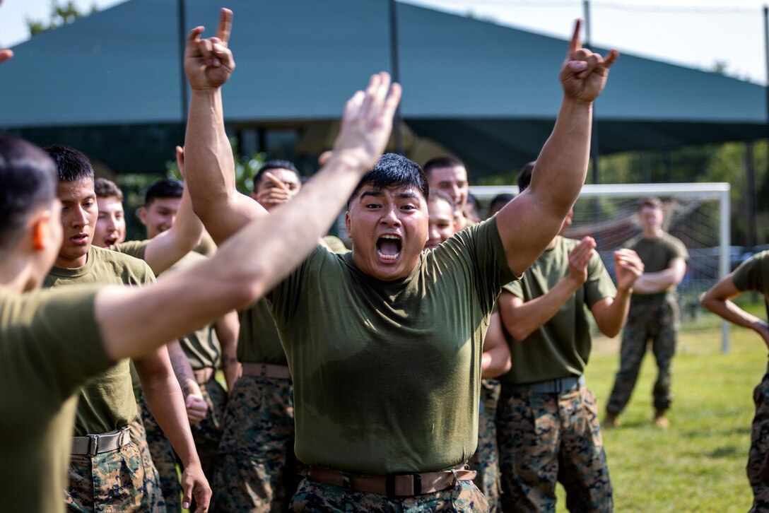 U.S. Marine Cpl. Roberto Salinas cheers on participants in the tire flipping challenge during a Security Battalion field meet on Marine Corps Base Quantico, Virginia, September 16, 2022. Field meets are held to test Marines on their physical fitness while also bringing the battalion closer together and boosting unit camaraderie. The meet included an ammo can relay race, tire flip challenge, and grappling. First place was Motor Transport Services, second place was Marine Corps Base Quantico Food Services, and third place was Installation Personnel Administration Center team two.  (U.S. Marine Corps photo by James Frank)