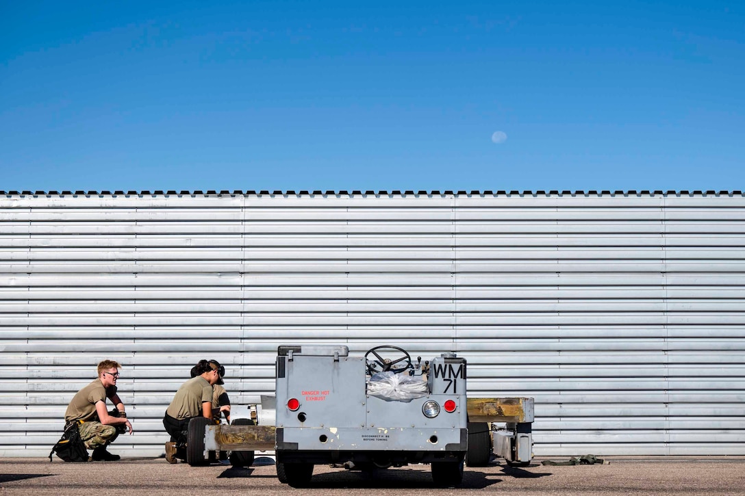 Airmen work on equipment.